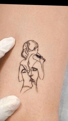 a woman's stomach with a tattoo on it that has a drawing of a woman