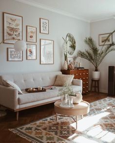 a living room filled with furniture and pictures on the wall