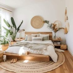 a bed sitting on top of a wooden floor in a bedroom next to a window