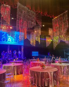 an indoor event with chandeliers and tables