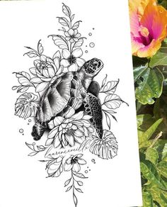 a black and white drawing of a sea turtle surrounded by flowers on a sheet of paper