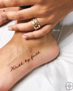 a woman's foot with the words wake me up tattooed on her left side