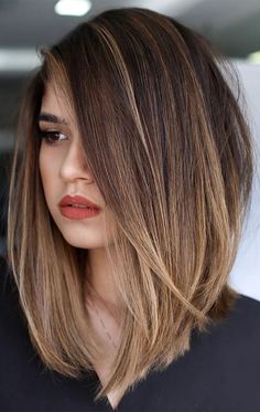 a woman with brown hair and red lipstick is looking off to the side while wearing a black shirt