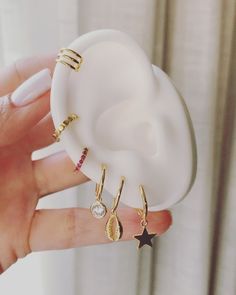 a person holding a fake earring in their hand