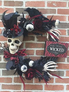 a skeleton wreath on the side of a brick wall with a sign that says, i'm wicked