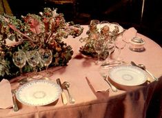 the table is set with plates and silverware