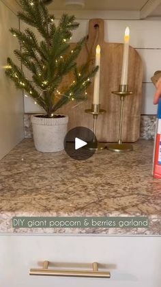 a kitchen counter with a christmas tree on it and a bottle of diy glant popcorn