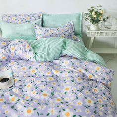 a bed with flowers on it and a cup of coffee in the corner next to it