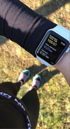 a person wearing an apple watch on their arm with the time displayed in front of them