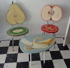 three chairs with fruit painted on them sitting in a room