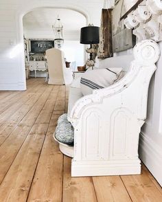 a white bed sitting on top of a wooden floor