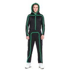 a man in black and green tracksuits standing with his hands on his hips