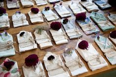 many pieces of cloth are laid out on the floor with flowers and ribbons tied around them