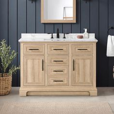 a bathroom vanity with two sinks and a mirror on the wall next to a rug