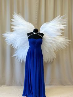 a blue dress with white feathers on it