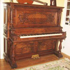 an old piano sitting in the corner of a room