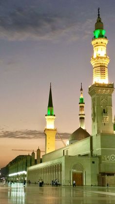 a large white building with green lights on top