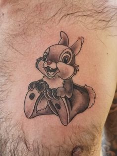 a man's chest with a cartoon character tattoo on it