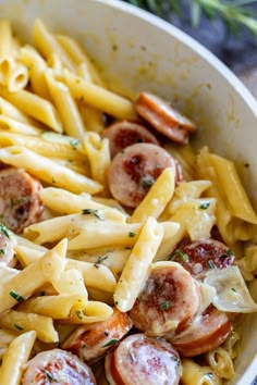 pasta with sausage and mushrooms in a white bowl