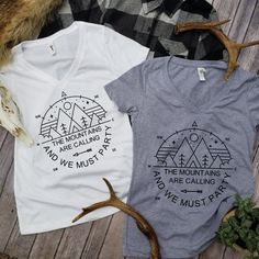 two t - shirts with deer antlers next to them