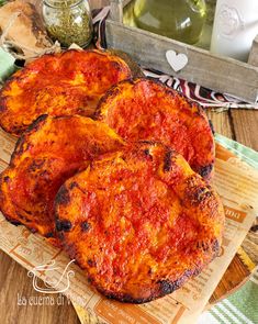 three pieces of pizza sitting on top of a cutting board next to other food items