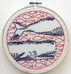 an embroidery pattern with fish and waves on it