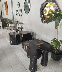 several tables and stools are lined up in a room with mirrors on the wall