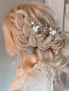 a woman with blonde hair wearing a wedding hairstyle