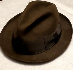 Vintage Royal Stetson Chocolate Brown Felt Fedora Hat Size 7 1/8.  Shipped with USPS Priority Mail. Very nice Chocolate Brown Royal Stetson Felt Fedora with a Black 2" Wide Ribbon. Has a brown leather sweatband and a light brown satin lining. Hat dates to the 1950's. Very good pre-owned condition, only the sweatband shows signs of wear and has a tear at the back. Please check out all of the pictures for condition and message me if you have any questions or would like to see additional pictures. Journalist Outfit Men, Fedora Hat Aesthetic, 60s Detective, Fedora Aesthetic, Detective Hat, Detective Outfit, 1930s Men, Brown Fedora, Detective Aesthetic