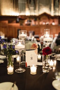 the table is set with candles and place cards for guests to sign their names on