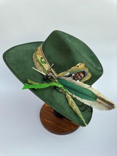 This hat has so much personality. It is an beautiful green with burnt design and vintage embellishments. This hat is a size large with an elastic inner band for the most comfortable fit. Please see size chart in the pictures. Green Hat Bands For Kentucky Derby, Adjustable Green Fedora Felt Hat, Adjustable Green Costume Hats With Short Brim, Adjustable Green Flat Brim Fedora, Western Green Hat Band For Festivals, Western Green Hat Bands For Festival, Green Western Style Hat Band For Festivals, Green Fedora For Kentucky Derby, Adjustable Green Fedora Hat Band