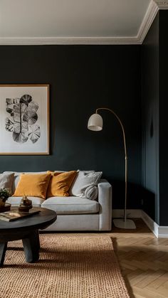 a living room filled with furniture and a painting hanging on the wall above it's coffee table