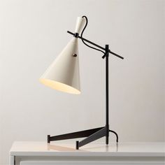 a white desk lamp sitting on top of a table