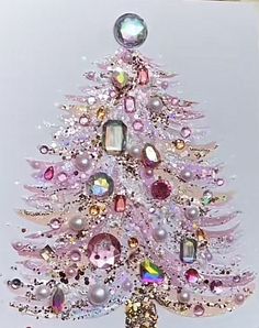 a pink christmas tree with lots of different colored stones