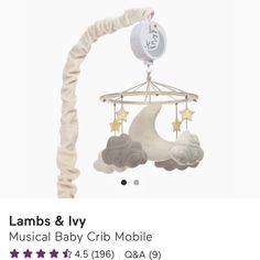 a baby crib mobile with stars hanging from it's back and the name lambs & ivy on top