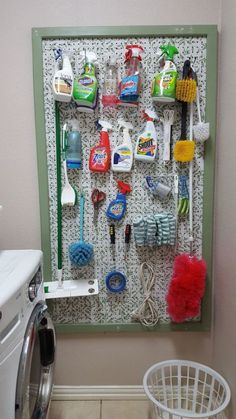 a dryer is next to a drying rack with cleaning supplies on it and a laundry basket