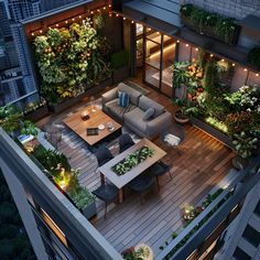 an aerial view of a living room and dining area in a high rise building at night