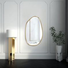 a white and gold room with a round mirror on the wall next to a lamp