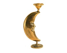 a golden statue of a man's face sitting on top of a crescent