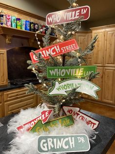 a christmas tree decorated with street signs and lights