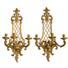 two gold - plated candelabras with candlesticks