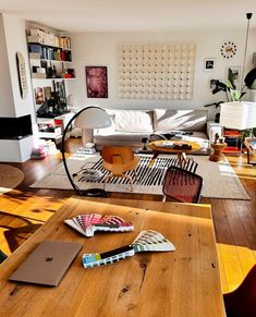 a living room filled with furniture and lots of clutter on top of a wooden table