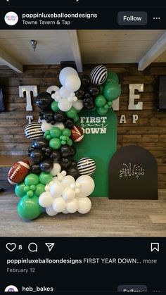 the balloon arch is decorated with footballs and balloons