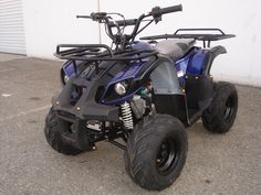 a blue four - wheeler parked in front of a building