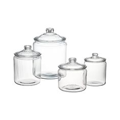 three glass jars with lids are shown in this image, and the bottom one is empty