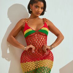 a woman in a red, yellow and green fishnet dress