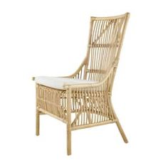 a wicker chair with white cushions on it