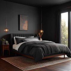 a bedroom with dark walls and wood floors, black bedding, two lamps hanging from the ceiling