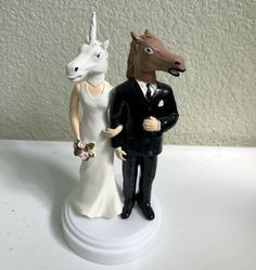 a figurine of a bride and groom with a horse head