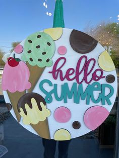 a sign that says hello summer in front of a window with an ice cream sundae